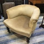 An Edwardian ebonised low back nursing chair with upholstered panel back and seat in gold velour,