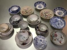 A group of English china blue and white saucers, tea bowls, teacups etc. with painted enamel