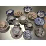 A group of English china blue and white saucers, tea bowls, teacups etc. with painted enamel