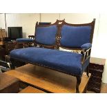 An Edwardian mahogany two seater drawing room sofa with pierced centre and upholstered panel back,