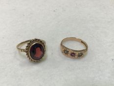 A 15ct gold ruby and pearl ring and a 9ct gold oval garnet set ring with rope pattern border (stone: