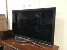 A Samsung LCD televison, model UE40C6540SK, complete with remote control and anodised metal stand