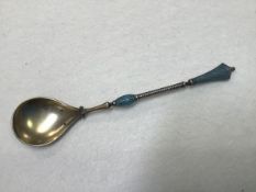 An Islamic marked Persian or Turkish white metal, gilt and enamelled spoon, stamped 925 verso (l.