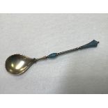 An Islamic marked Persian or Turkish white metal, gilt and enamelled spoon, stamped 925 verso (l.