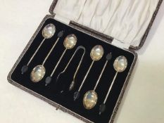 A set of six Birmingham silver bean handled coffee spoons with matching tongs, in original fitted