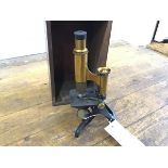 A 19thc bronze and brass mounted table microscope, Henry Crouch, London, no. 4500, complete with