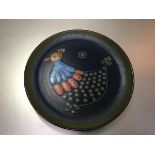 A Continental pottery plate decorated with stylised chicken design, c.1960 (d.28cm)