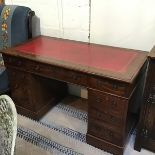 An Edwardian mahogany twin pedestal kneehole desk, the rectangular top with moulded edge, with inset