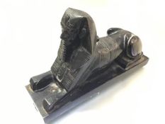 A 1930s cast metal sphinx figure with black painted enamel decoration (h.15cm x 26cm x 8cm)