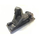 A 1930s cast metal sphinx figure with black painted enamel decoration (h.15cm x 26cm x 8cm)