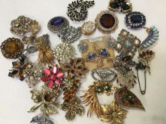 A large collection of paste set brooches including spray brooches, leaf brooches etc. (a lot)