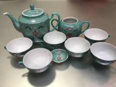 A modern Chinese turquoise ground floral decorated part teaset including teapot, sugar basin, five