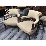 A pair of Edwardian walnut horseshoe back tub chairs with upholstered panel backs, arms and seat, in