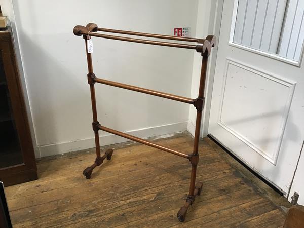 A Victorian walnut upright four bar towel rail, raised on turned end columns and shaped block and