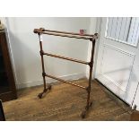 A Victorian walnut upright four bar towel rail, raised on turned end columns and shaped block and