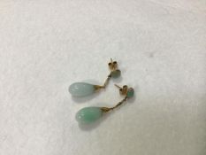 A pair of pale celadon jadeite pear shaped drop earrings mounted on 14ct gold chain and post (4cm