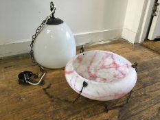 An opaque snowdrop style glass pendant light fitting with bronzed metal fixing and a 1930s pink