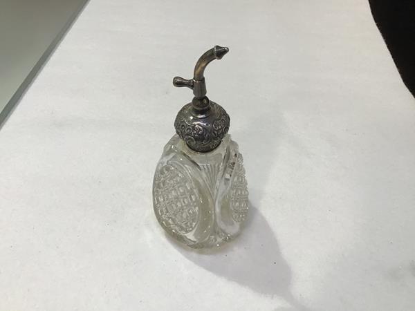 A crystal triangular tapered perfume bottle mounted with Birmingham silver chased top (missing