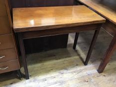 A 19thc mahogany rectangular foldover tea table, the top with moulded edge above a plain frieze,