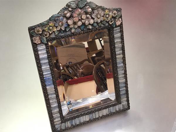 A 1930s barbola style table mirror with floral and leaf surmount, with blue decorated ribbon border,