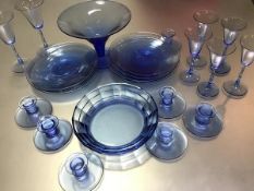 A collection of blue glass dessert plates, comport, glassware and seven candlesticks (tallest glass: