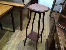 An Edwardian stained two tier plant stand, the shaped top on curved moulded square supports (h.