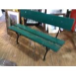 A rustic cast iron support garden bench with single panel back and twin panel seat, in green painted