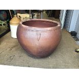 A large terracotta high fired glazed ovoid tapered garden pot with applied leaf style moulded detail