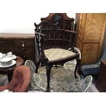 An Edwardian mahogany pierced horseshoe shaped open armchair with splat style back and inset seat,