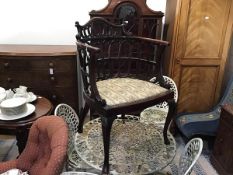 An Edwardian mahogany pierced horseshoe shaped open armchair with splat style back and inset seat,