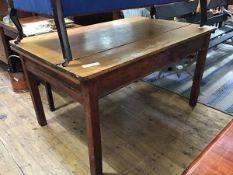 A 19thc pine kitchen table, the rectangular plank top with moulded edge, above a single frieze