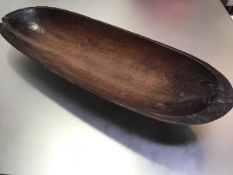 A 19thc treen rectangular serving dish with hand carved centre, with notched pierced hanging hole