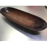 A 19thc treen rectangular serving dish with hand carved centre, with notched pierced hanging hole