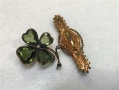 A yellow metal mounted four leaf green stone set shamrock with seed pearls (one pearl missing) (d.