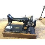 A Singer Manufacturing Company hand sewing machine, model EC574608, complete with instructions (