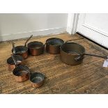 A set of late 19thc copper graduated cast iron handled pans, (sized d. 14cm 16cm 18cm 20cm 24cm
