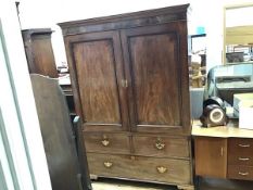 A George III mahogany linen press, the moulded cornice above a pair of fielded crossbanded panel