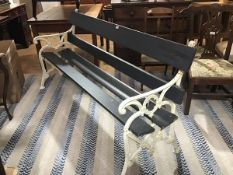 A wrought iron ended garden bench with slatted back and seat with grey painted finish (h.85cm x