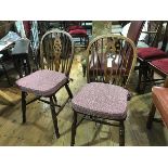 A pair of oak and elm Windsor style pierced splat and spar back kitchen chairs with shaped wood