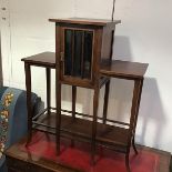 An Edwardian mahogany miniature display stand, the square top above a glazed panel door, enclosing a