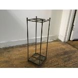 An Edwardian cast brass four section upright open stick stand, on cast iron base (h.54cm x 18cm x