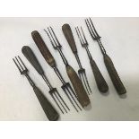 A group of three horn handled and four treen handled three prong 19thc. forks (longest: 20cm)