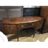 A George III mahogany bow front sideboard, the top with moulded edge above a centre frieze drawer,