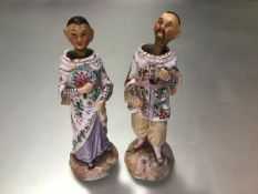 A pair of 19thc Continental bisque Chinese standing figures with nodding heads mounted on springs,