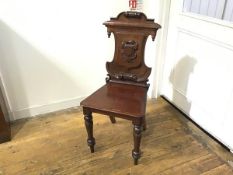 A Victorian mahogany shield back hall chair with shaped seat, raised on turned tapered supports (