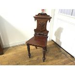 A Victorian mahogany shield back hall chair with shaped seat, raised on turned tapered supports (