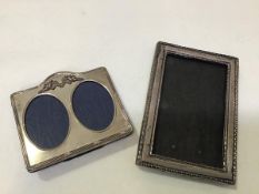 A modern London silver twin frame oval photograph frame with cherub and ribbon surmount (11cm x
