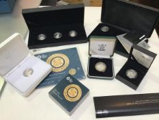 A two pound proof coin, two one pound Last Round coins, a silver one pound coin, a set of three