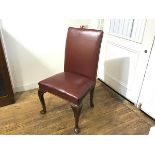 A George III style walnut framed library chair with upholstered oxblood leather panel back and seat,