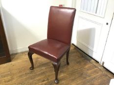 A George III style walnut framed library chair with upholstered oxblood leather panel back and seat,